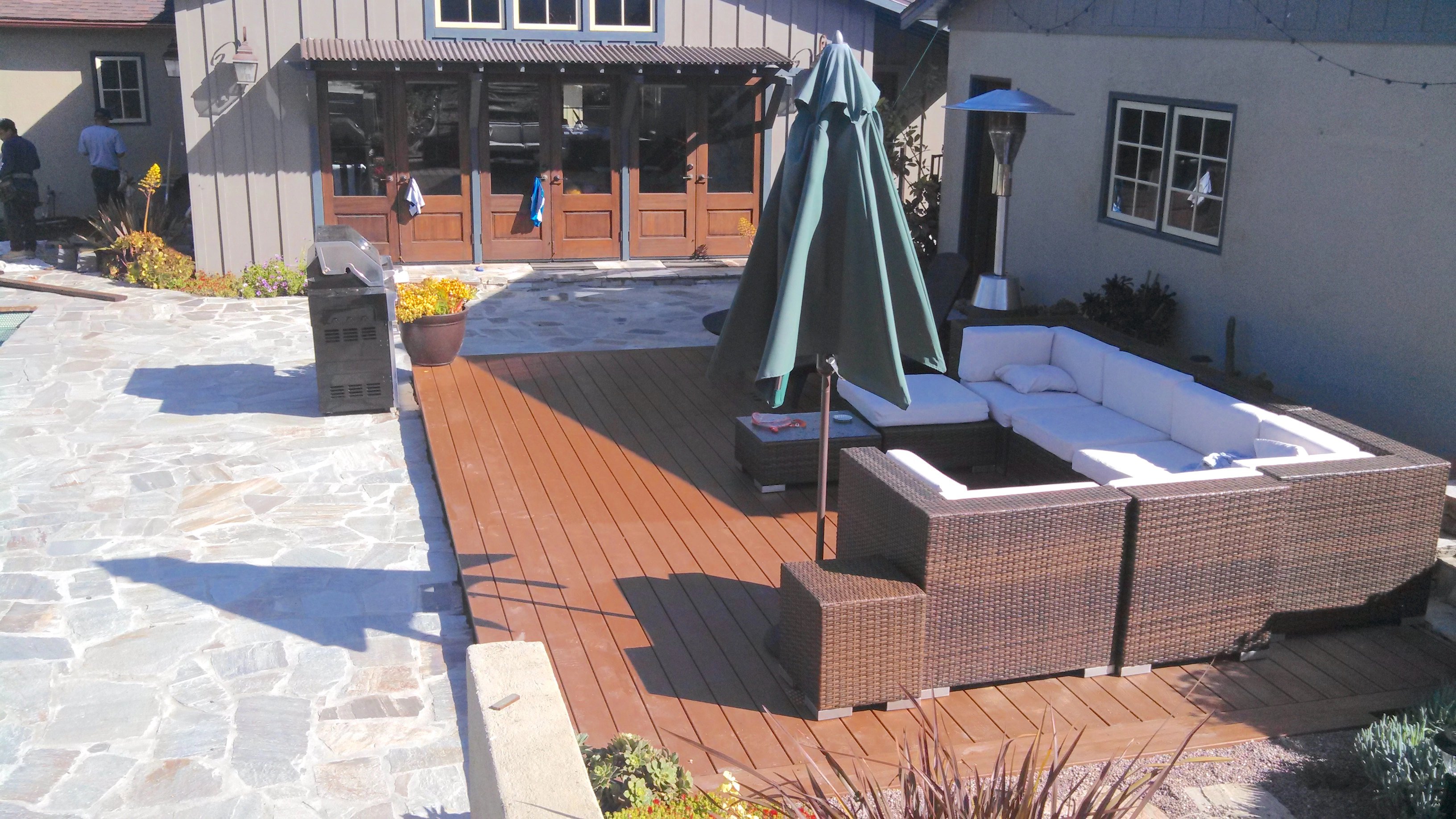 A ground level custom trex composite deck installed poolside for durability. 