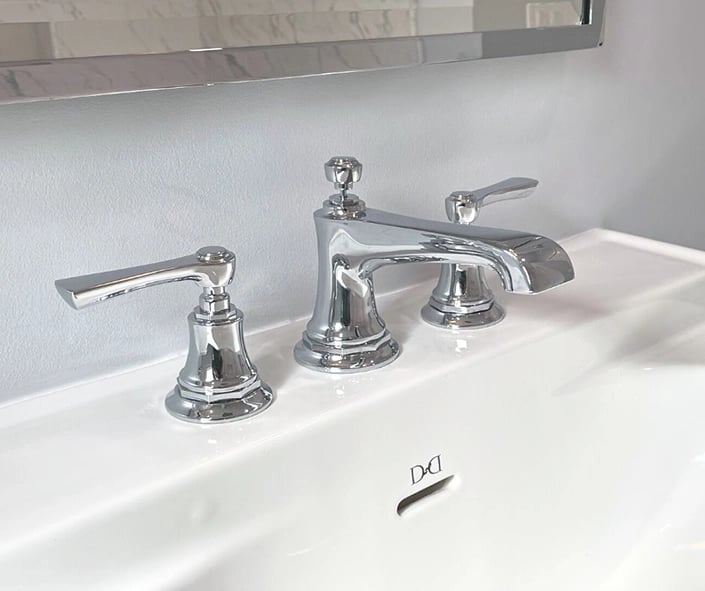 A close up view of the widespread chrome faucet by Brizo.