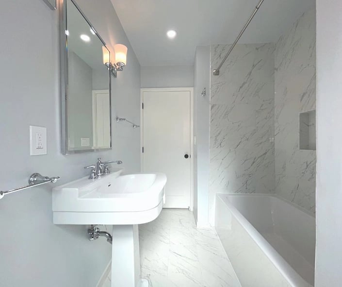 Side view of the small bathroom that was remodeled. A pedestal sink gave the room a classic look without taking up space. 