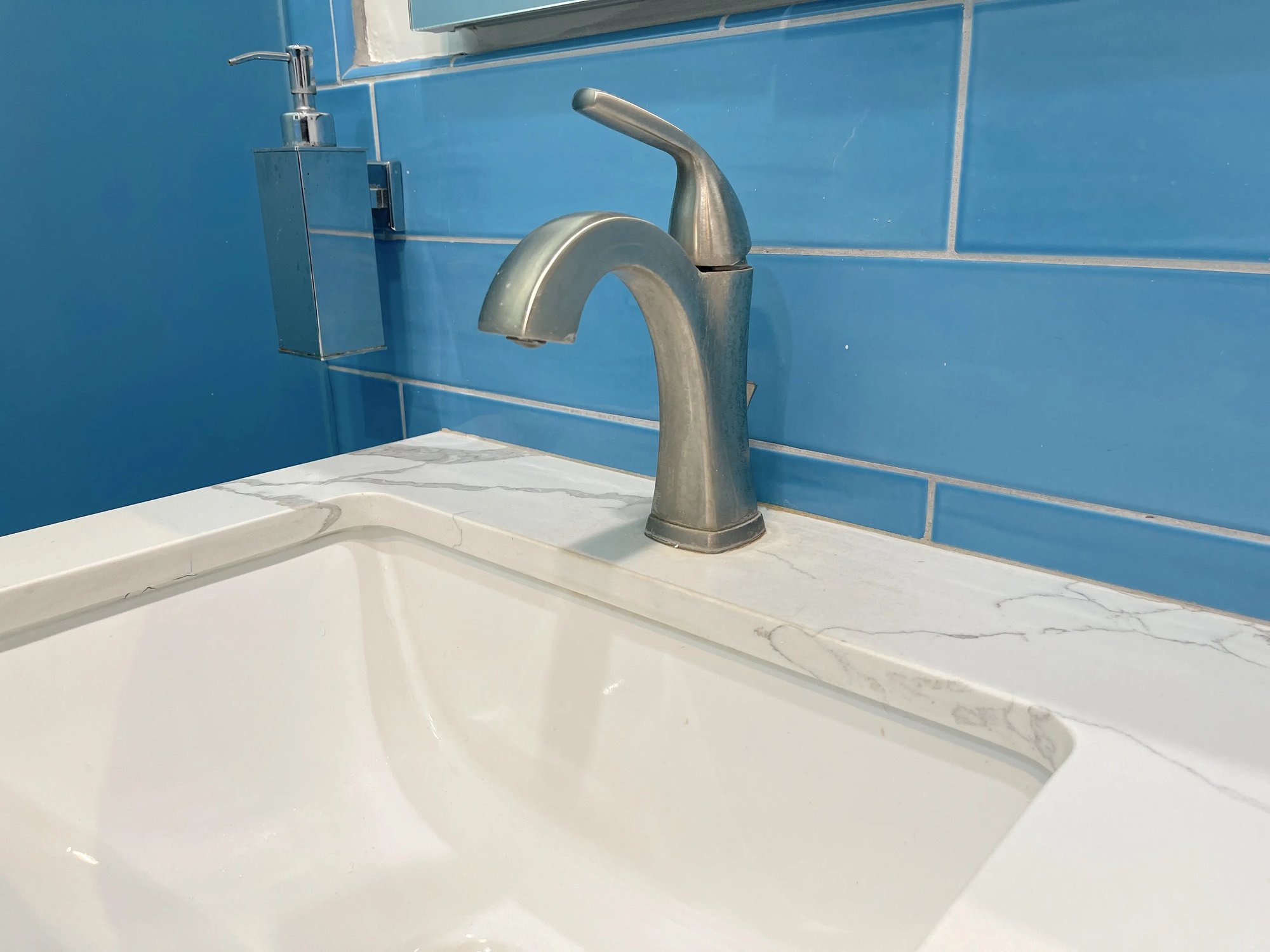 The sink was under mounted and a single hole faucet installed for the master bathroom remodel.