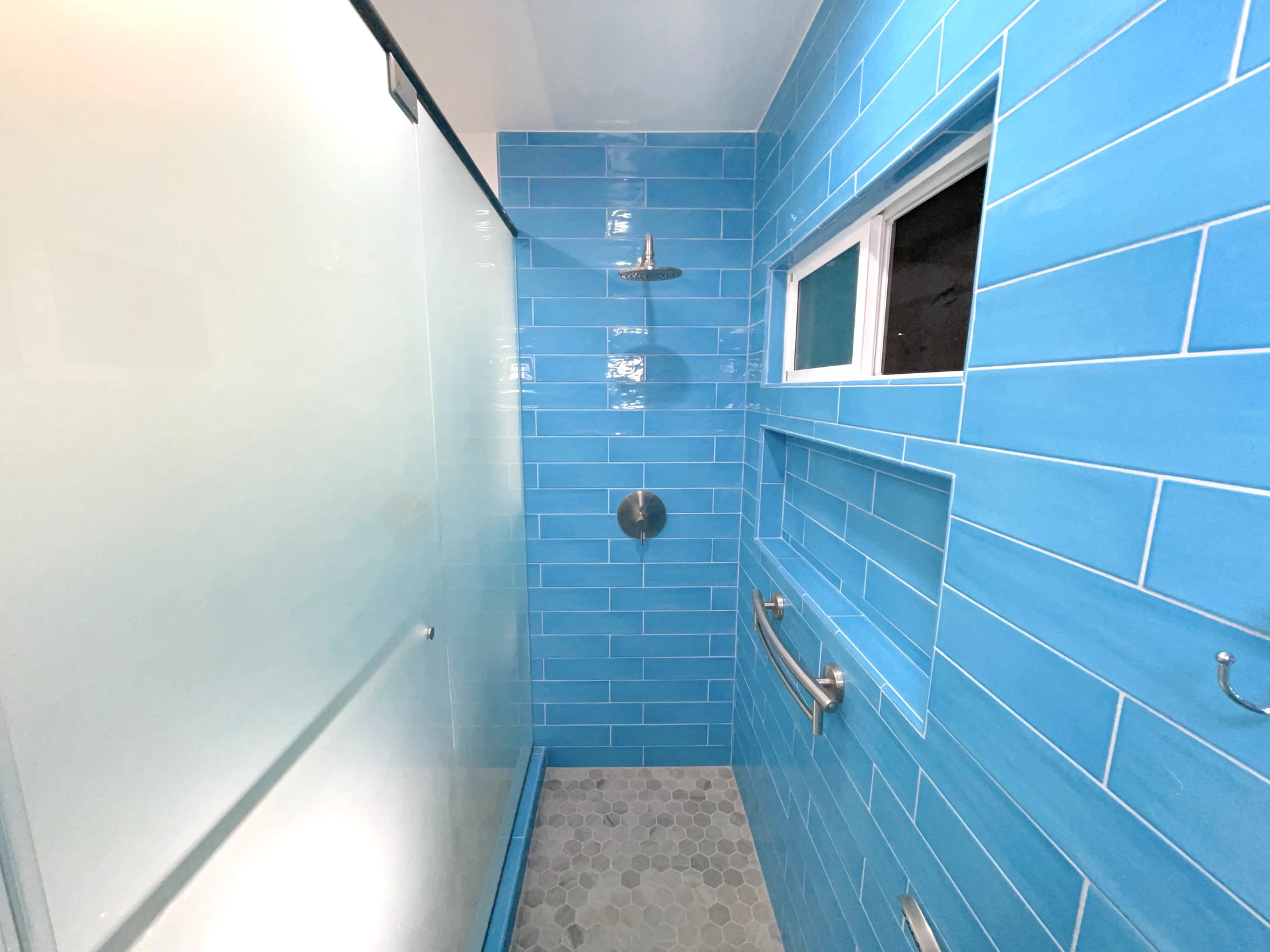 A look at the frosted glass paneling from inside the walk in shower.