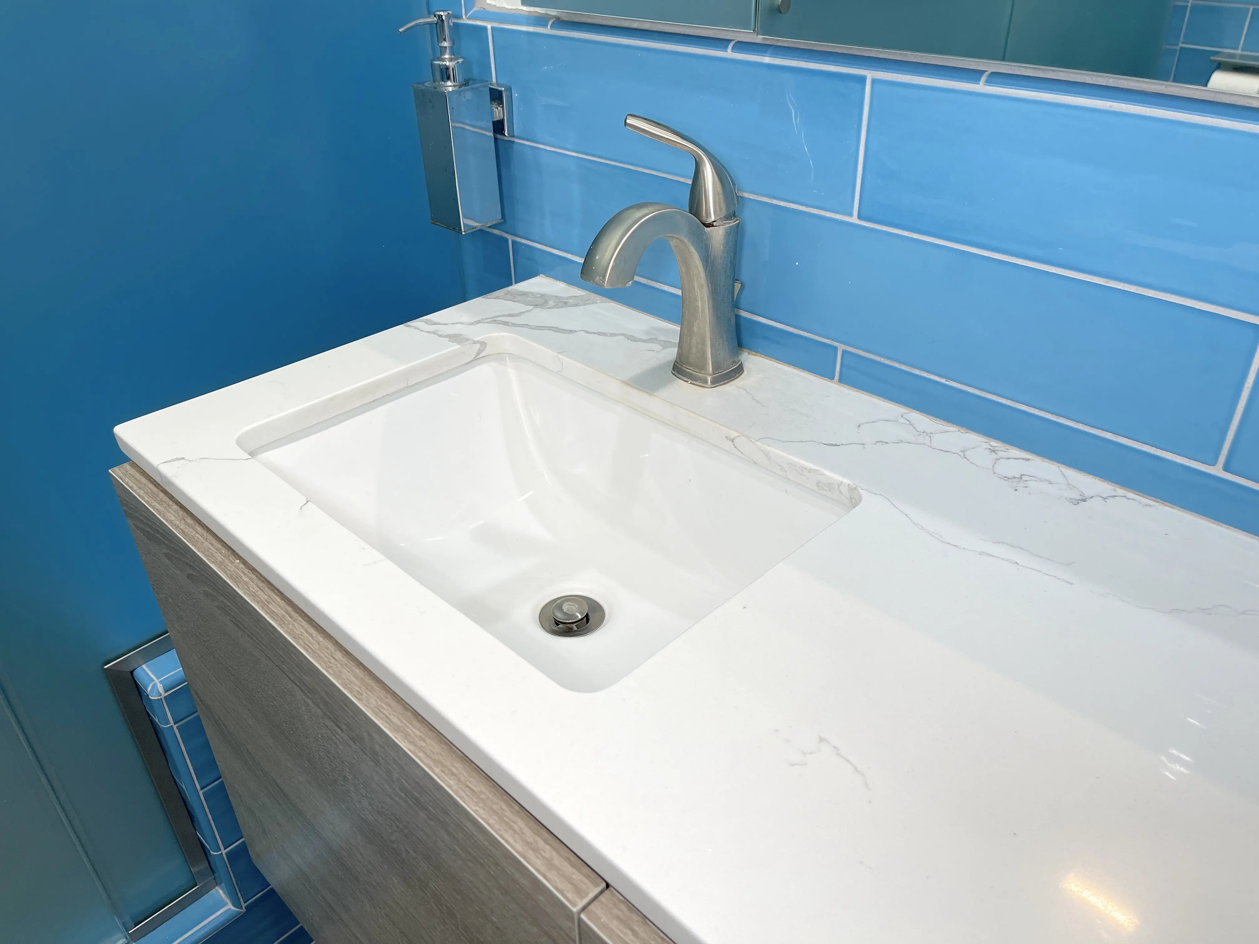  A custom cut countertop of calacatta laza quartz was used in the remodel of this master bathroom for its marble look. 