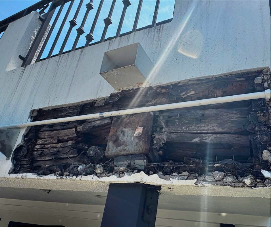 Exposed structural damage after demo discovery showing extensive dry rot in framing